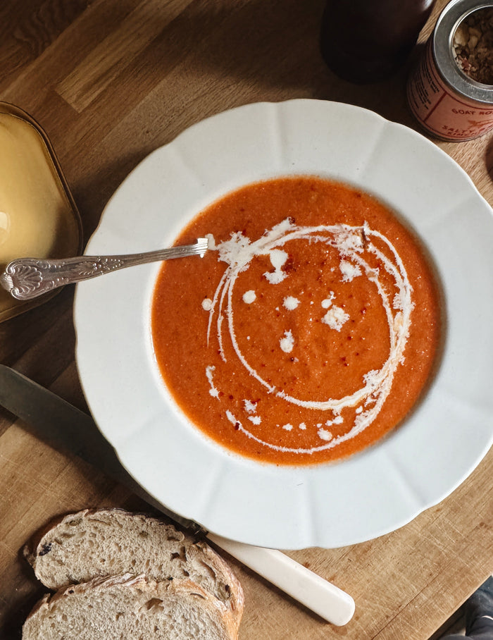 silky tomato soup garnished with cream and salt