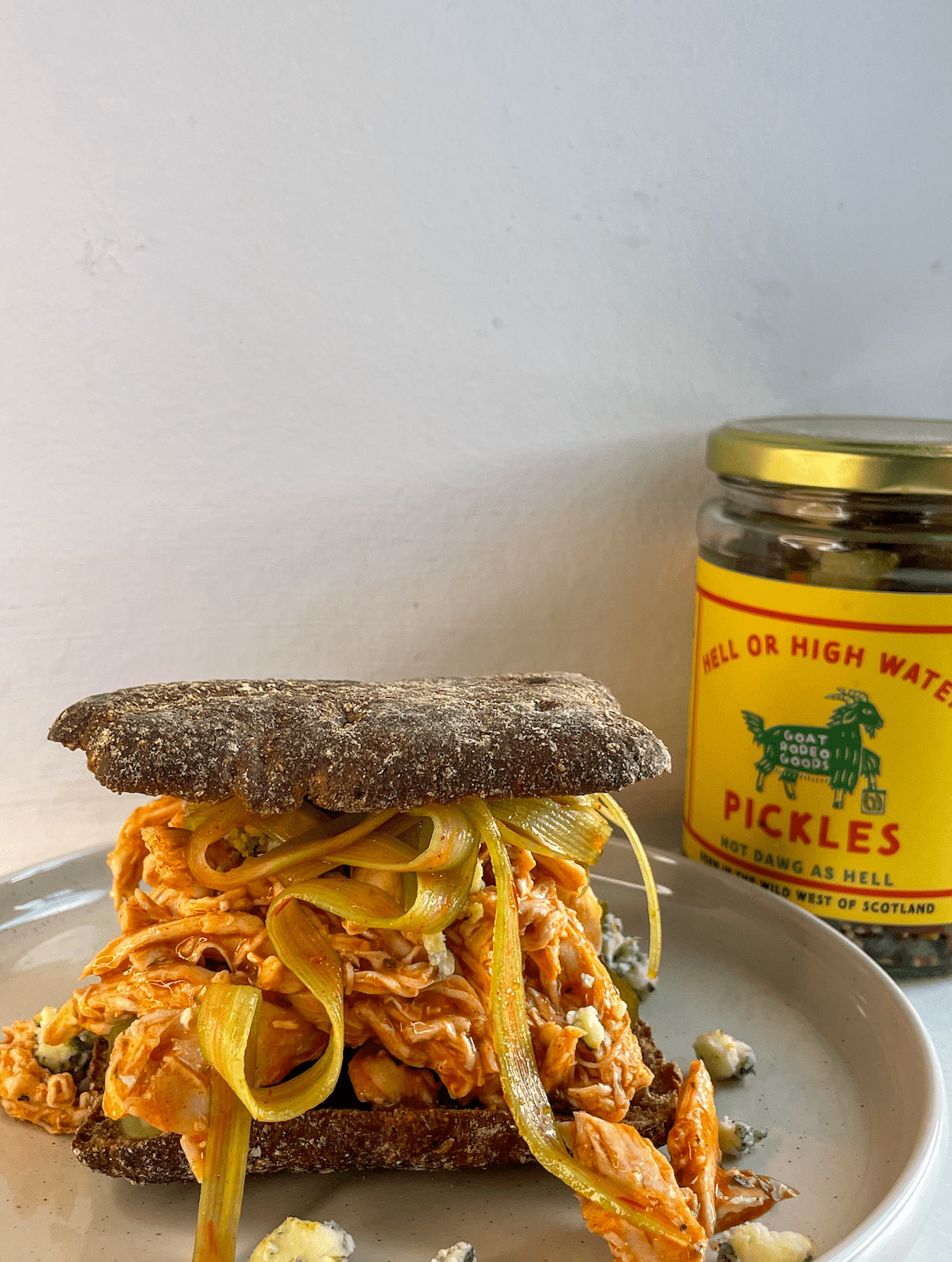 Rai Rai's STACKED shredded buffalo chicken sandwich with a blue cheese crumble and hell or high water pickles